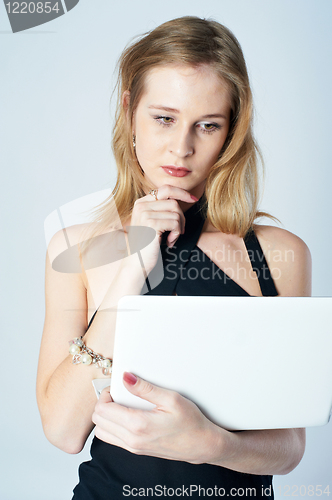 Image of Attractive blonde girl with laptop