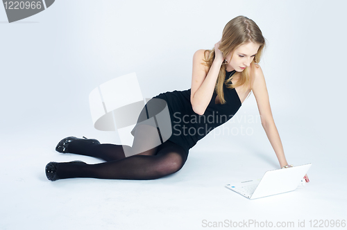 Image of Attractive blonde girl with laptop