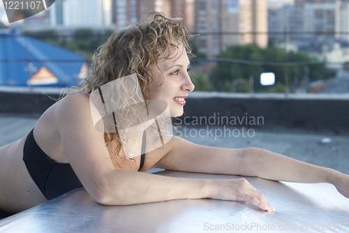Image of Young woman on roof
