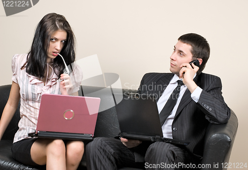 Image of Businessmen with computers on sofa