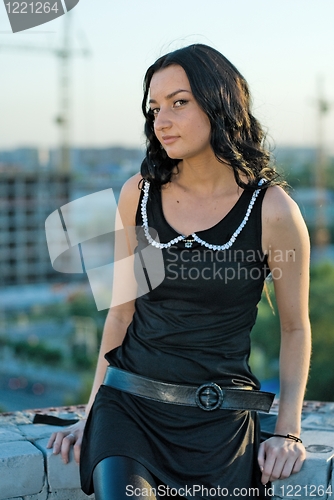 Image of Girl sitting on roof