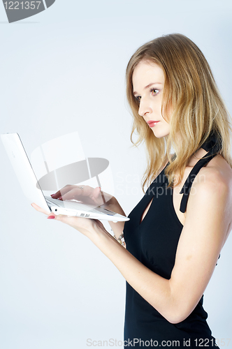 Image of Attractive blonde girl with laptop