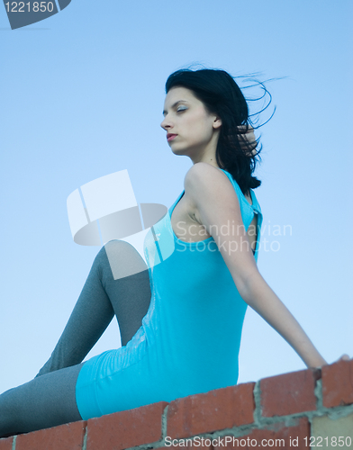 Image of Young woman on roof