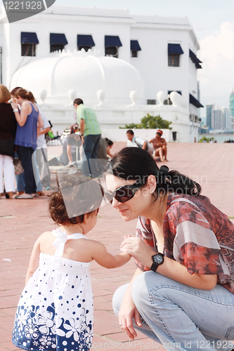 Image of Mother speaking to her baby in the park