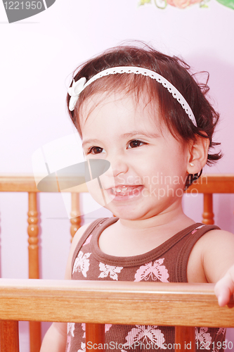 Image of Adorable baby girl in nursery