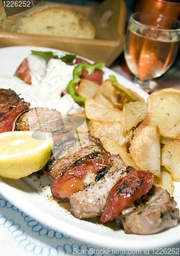 Image of pork souvlaki with tzatiki house wine bread 