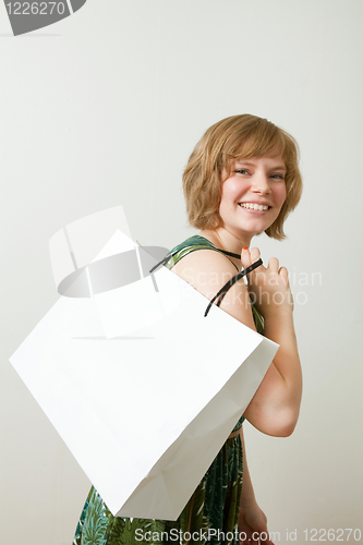Image of Young woman with shopping bag