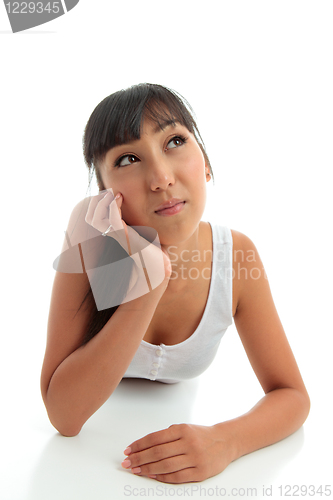 Image of Young woman thinking or with a question