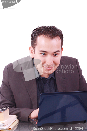 Image of Businessman with amazed expression using a laptop 