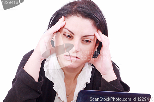 Image of tired young woman in the office at the workplace suffers headaches. Isolated on white 