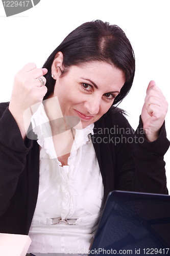 Image of Business woman happy in front of her laptop at the office