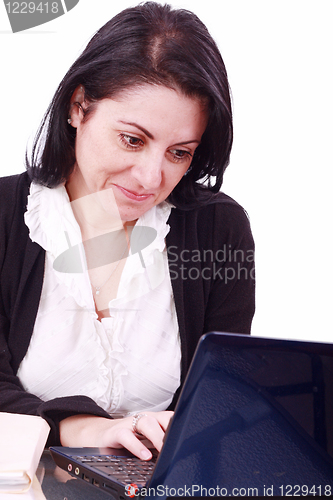 Image of Beautiful businesswoman working on laptop in the office 