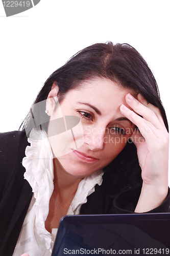 Image of Sad business woman in office working with laptop. Headache! 