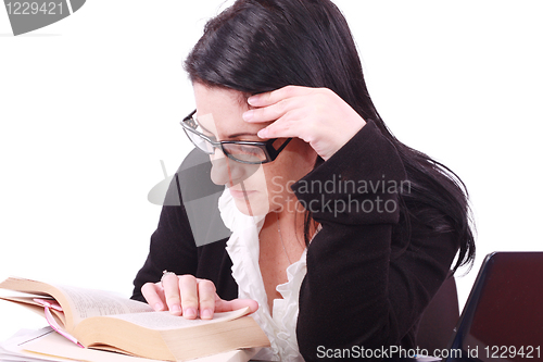 Image of Beautiful young business woman reads the book in office 