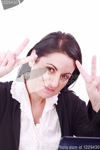 Image of A pretty arabic american business woman signaling success at office 