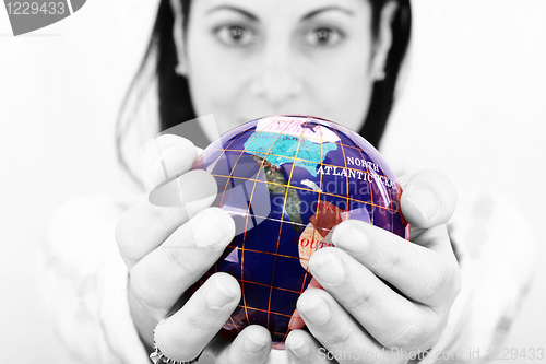 Image of woman holding the world in her hands