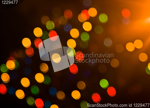 Image of Blurred festive colorful lights over black 
