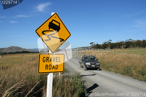 Image of gravel road warning sign