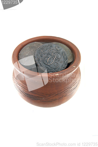 Image of Old traditional clay mug with ancient coins