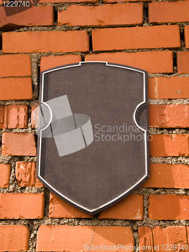 Image of tablet on a stone wall