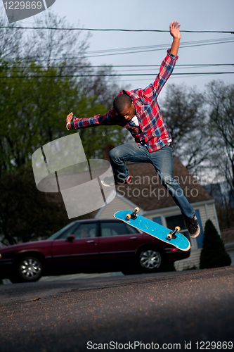 Image of Skateboarder Man Doing a Kick Flip