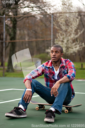 Image of Skateboarding Guy Taking a Rest