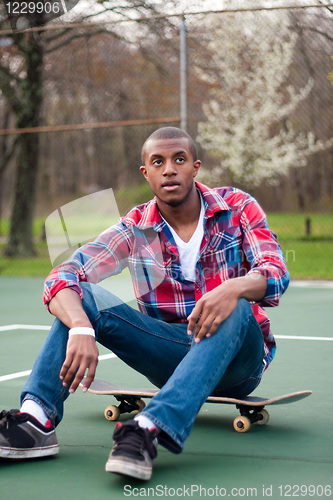 Image of Skateboarding Guy Taking a Rest