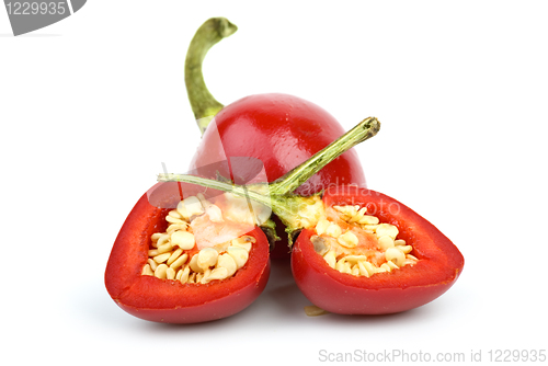 Image of Whole round red hot pepper and two halves