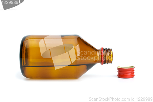 Image of Bottle with liquid and cap near