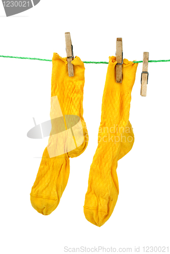 Image of Pair of yellow socks hanging on the rope