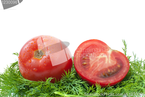 Image of Ripe red tomato and half ower some dill