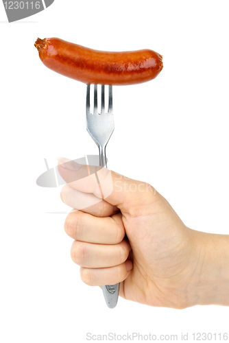 Image of Hand holding grilled sausage on the fork