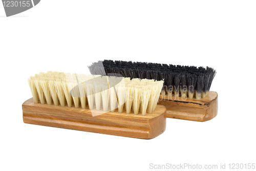 Image of Dirty (black) and new (white) clothes (or shoe) brushes