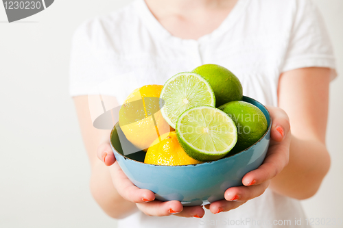 Image of Woman with lemon and lime