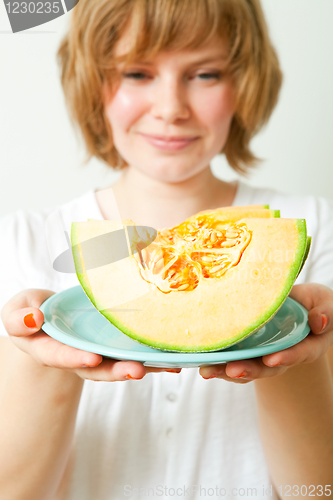 Image of Woman with cantaloupe melon