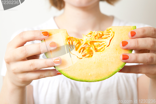 Image of Woman with cantaloupe melon