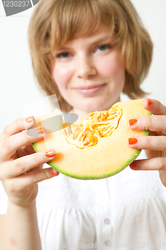 Image of Woman with cantaloupe melon