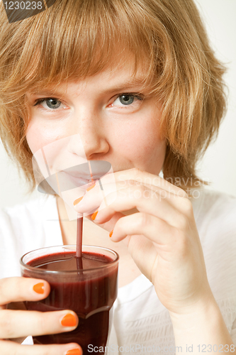 Image of Woman drinking blueberry smoothie