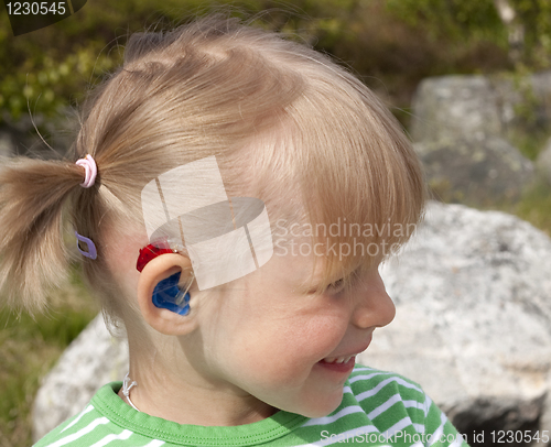 Image of Smiling child with hearing aid