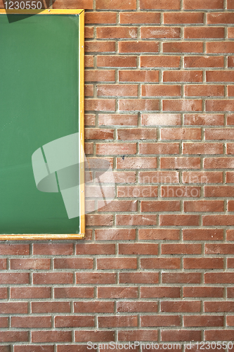 Image of Brick wall with green blackboard