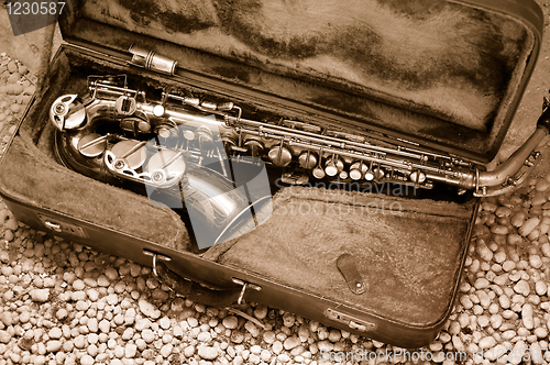 Image of Saxophone in old leather case – still life