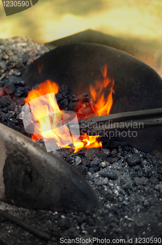 Image of Blacksmith heating up iron - detail