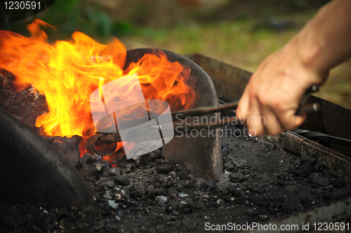 Image of Blacksmith heating up iron - detail