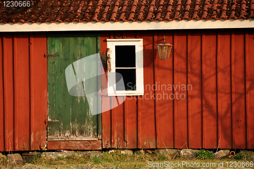 Image of Red house with green door