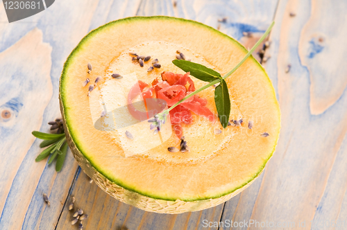 Image of fresh melon soup with parma ham and lavender flower