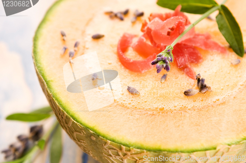 Image of fresh melon soup with parma ham and lavender flower