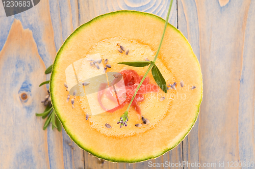 Image of fresh melon soup with parma ham and lavender flower