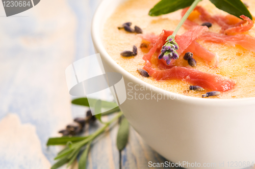 Image of fresh melon soup with parma ham and lavender flower