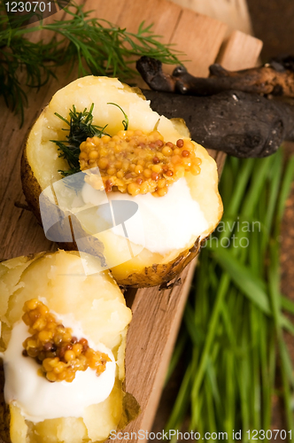 Image of Baked potato with sour cream, grain Dijon mustard and herbs