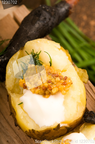 Image of Baked potato with sour cream, grain Dijon mustard and herbs